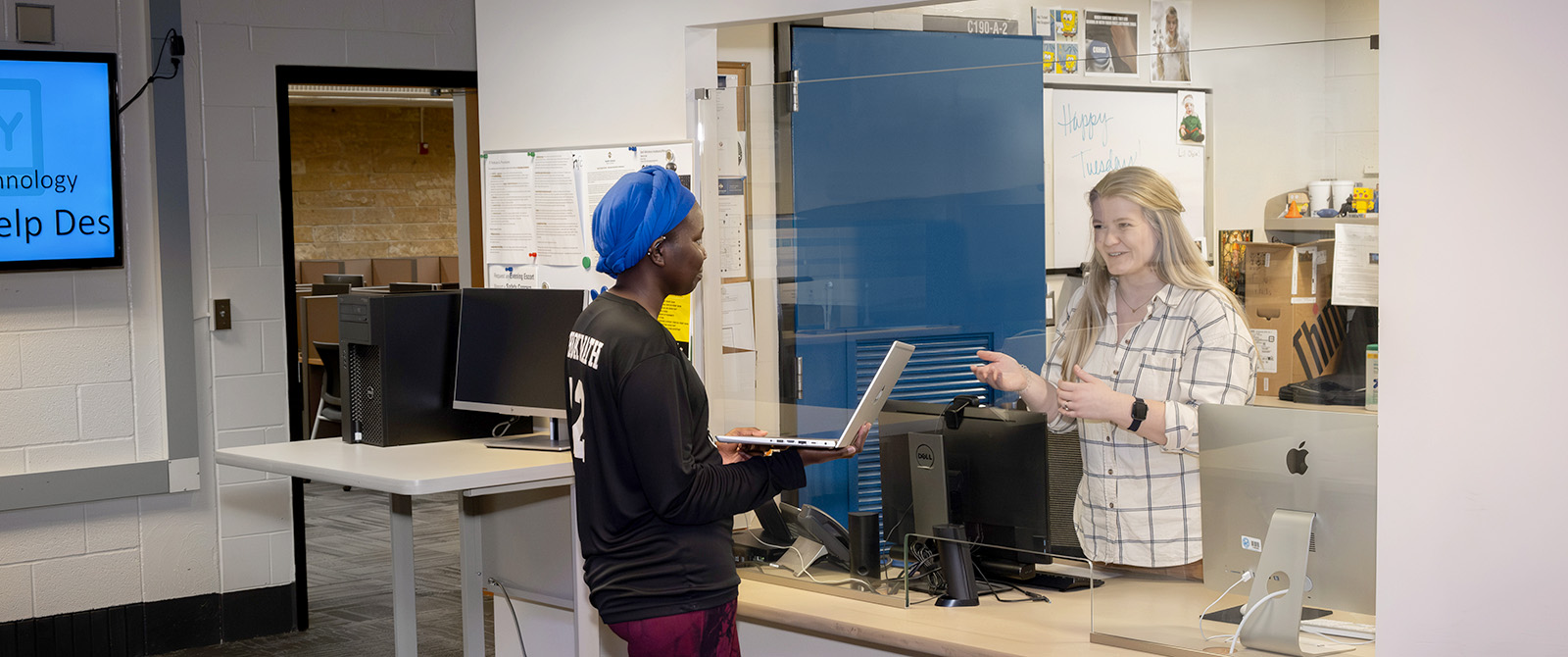A student asking a computer question at the Help Desk