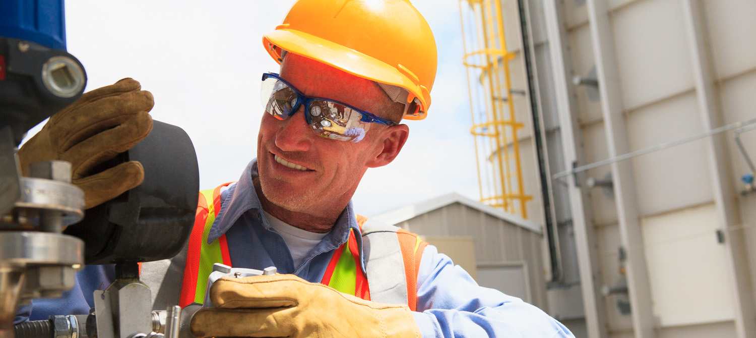 Photo of Ag technician repairing valve.